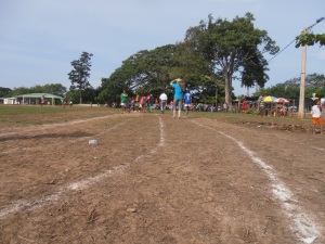 The track that surrounds the football/baseball field. And they run barefoot!